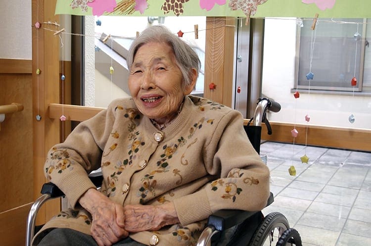 Older woman in a wheelchair smiling