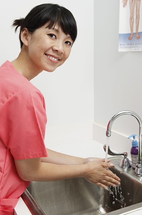 A woman washing her hands.